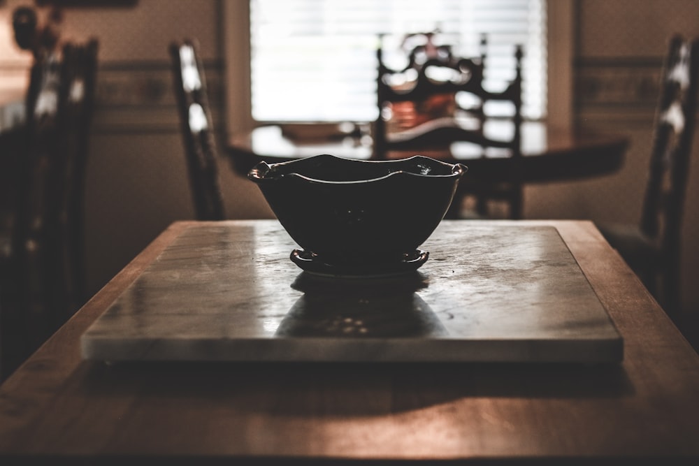 a bowl sitting on top of a wooden table