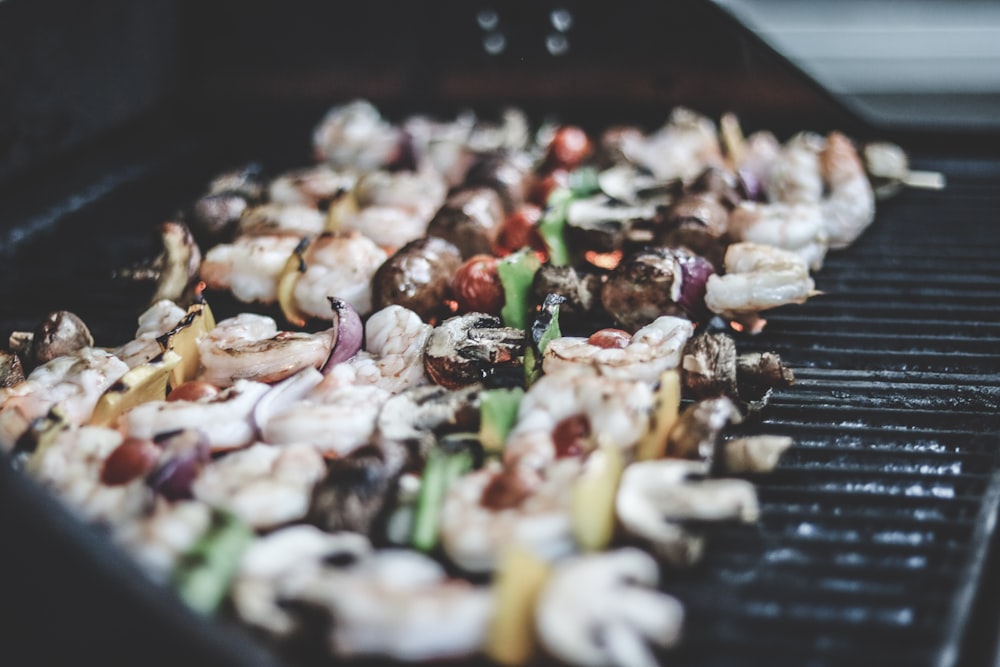 a bunch of food is cooking on a grill