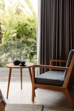 A beautifully arranged living room featuring an accent chair and a folding card table.