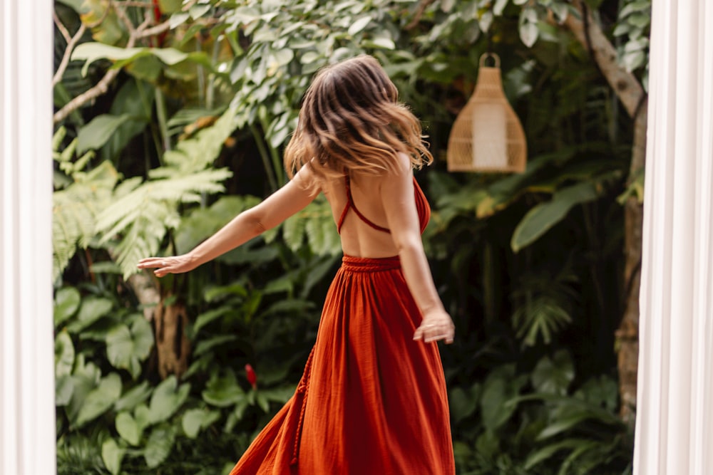 a woman in a red dress is walking