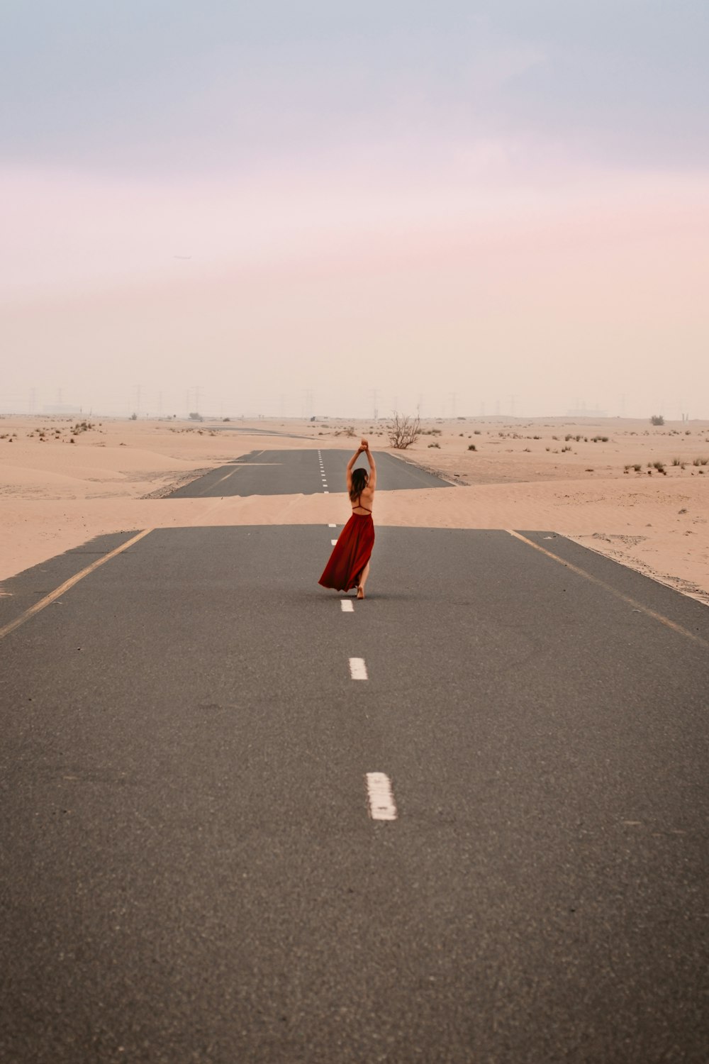a person standing in the middle of an empty road