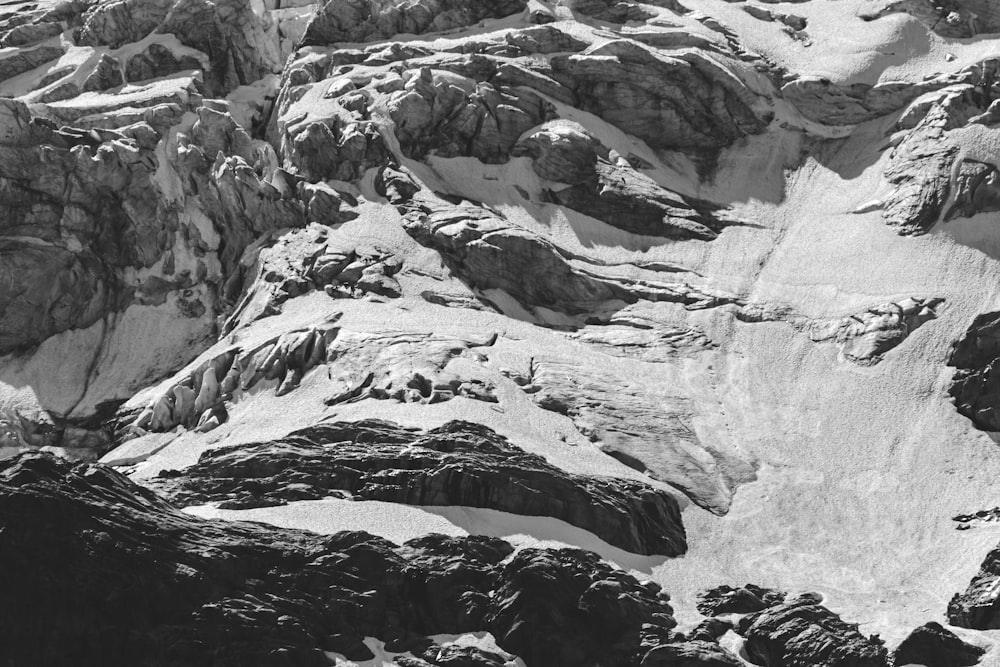 a black and white photo of snow covered mountains