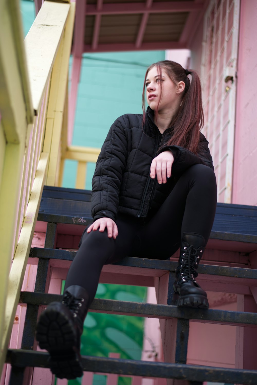 a woman sitting on top of a set of stairs