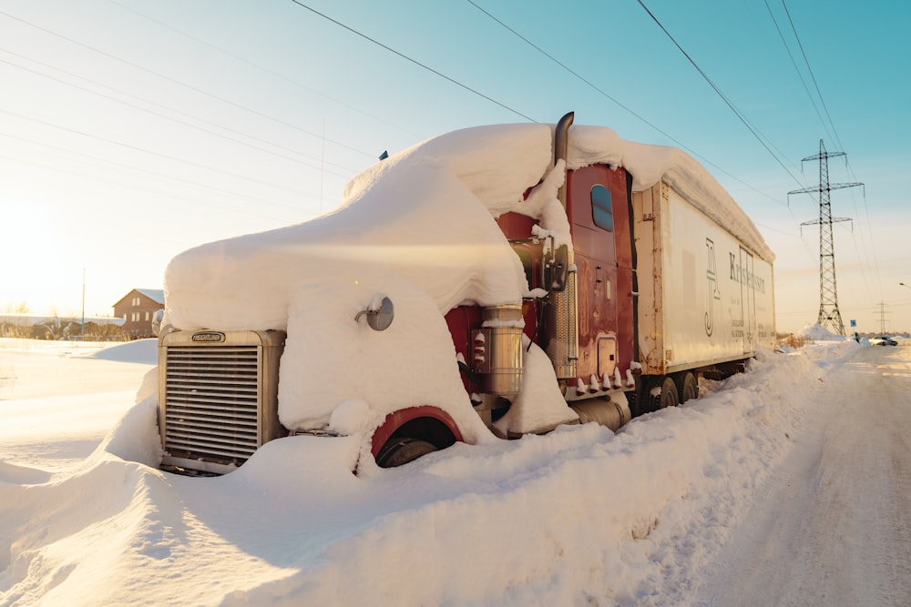 a truck covered in snow on the side of a road