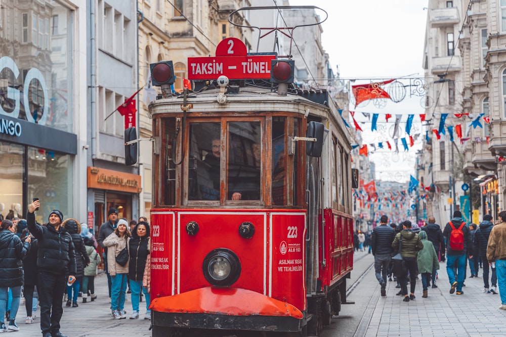 a red trolley car on a city street