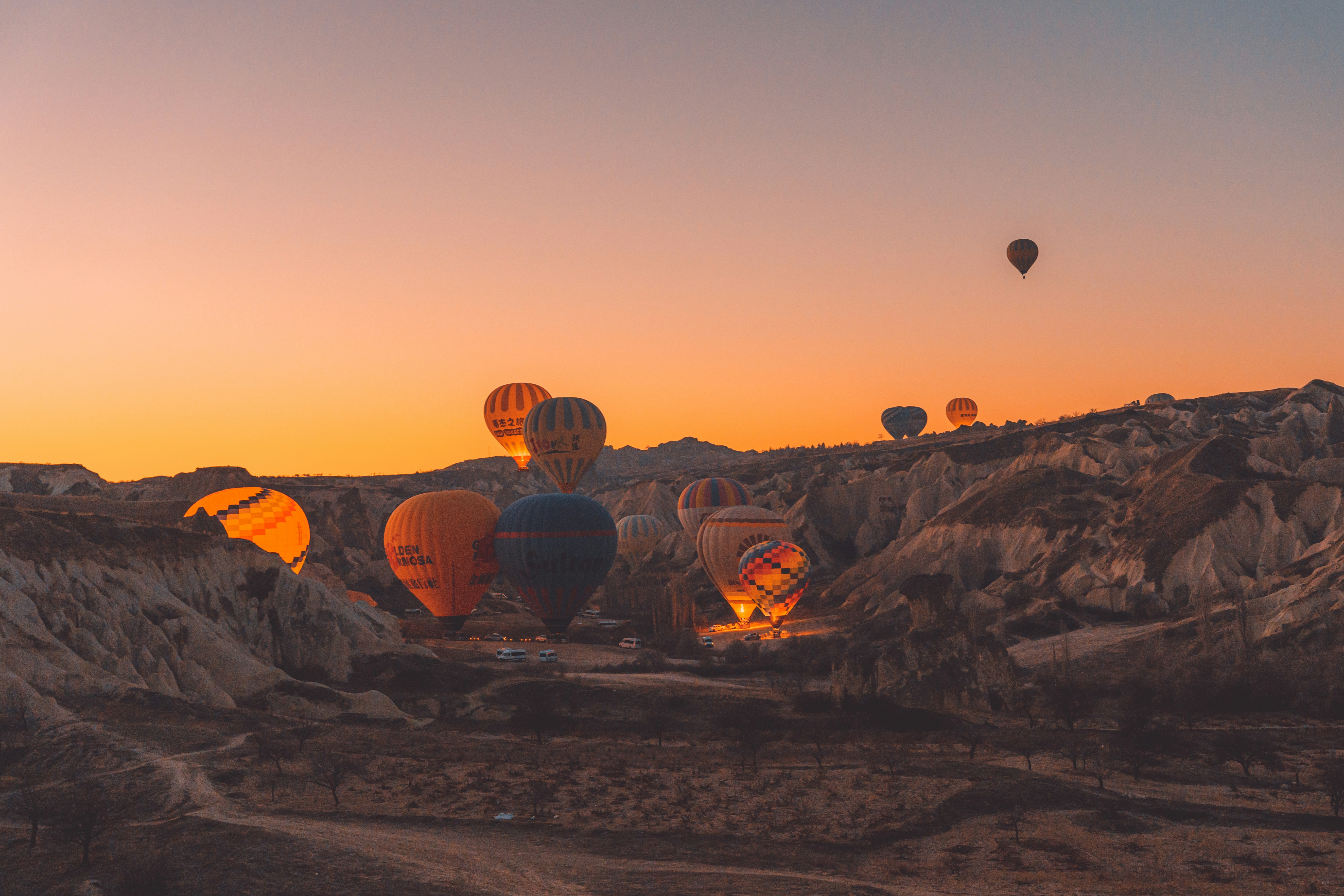 a group of hot air balloons flying in the sky
