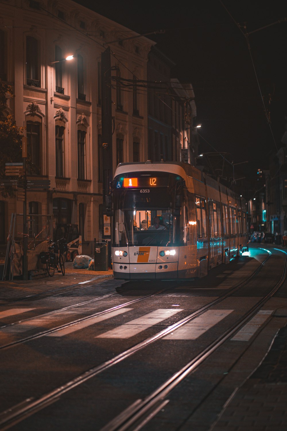 a public transit bus on a city street at night