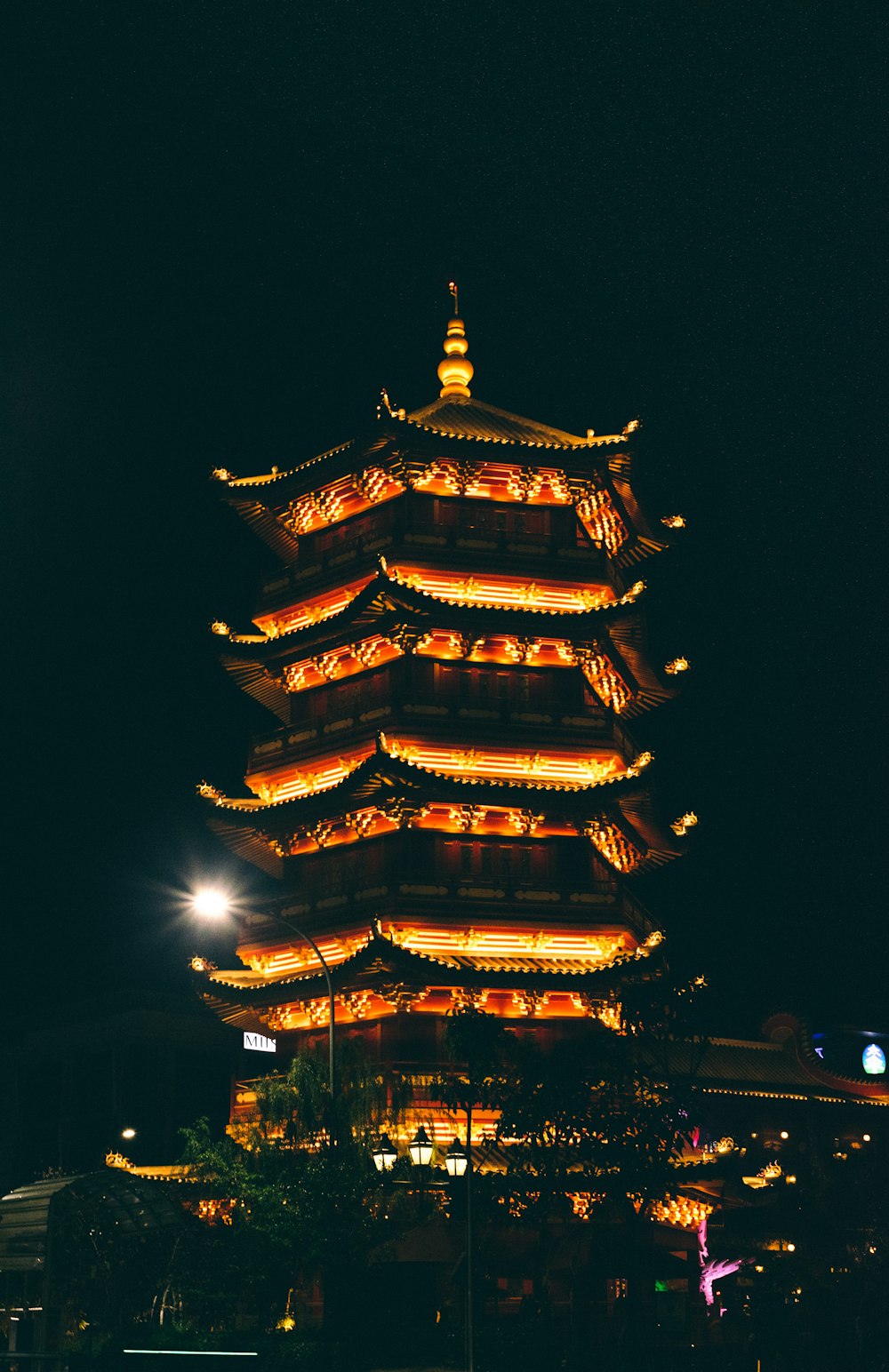 a tall tower lit up at night with lights