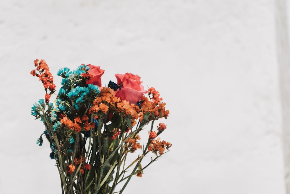 a vase filled with colorful flowers on top of a table