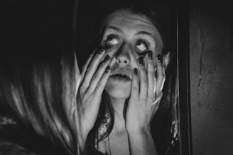 a woman with her hands on her face
