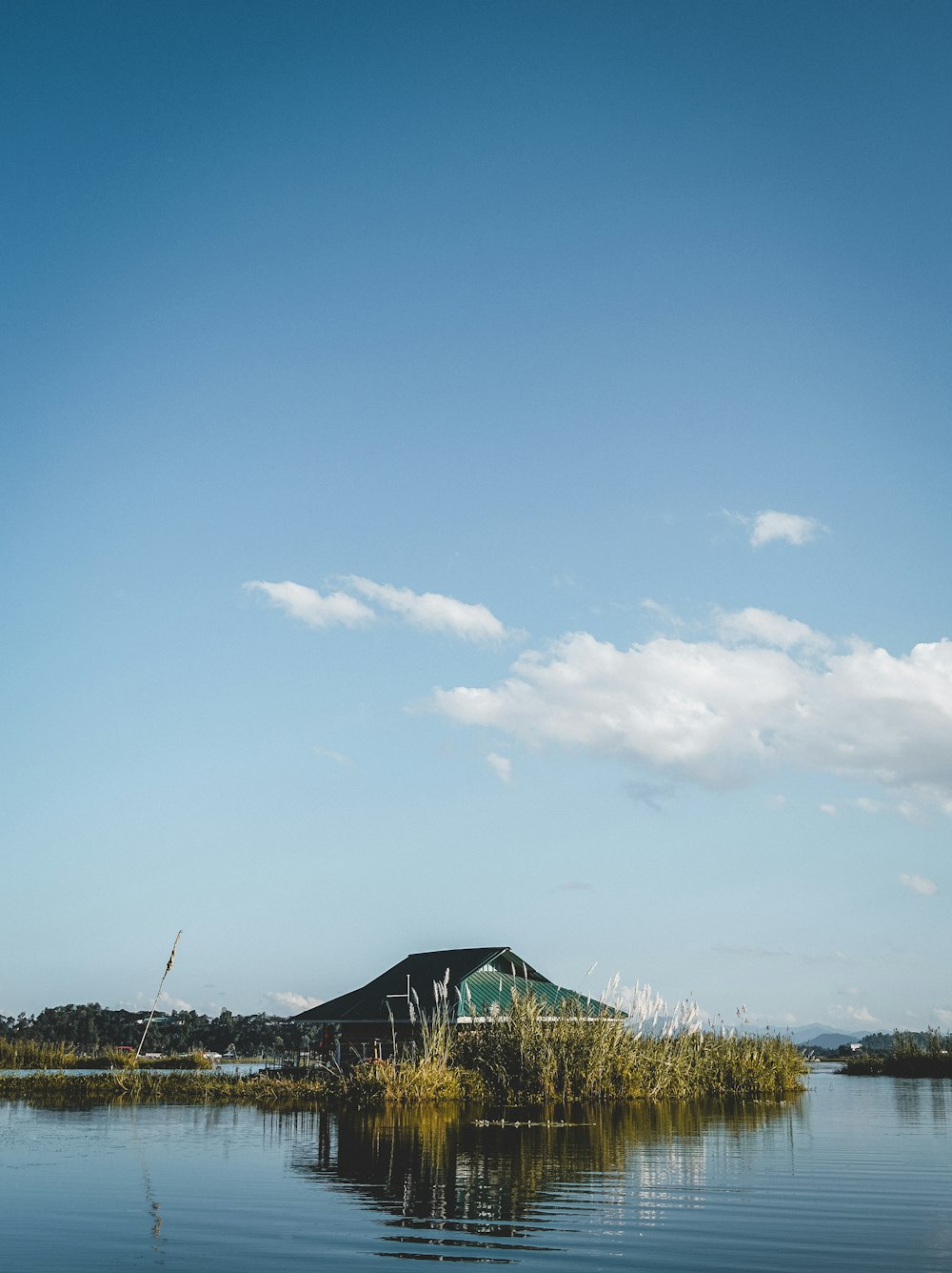 a house on a small island in the middle of a lake