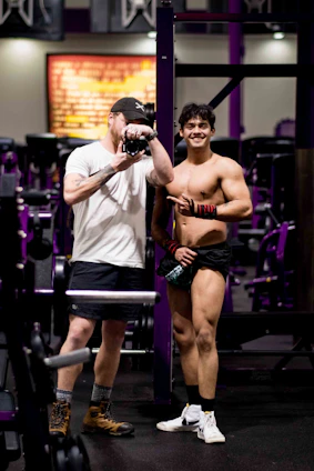 A dynamic photo of a fitness influencer collaborating with a sports brand representative in a modern gym setting.