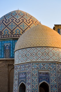 a close up of a building with a blue and gold dome