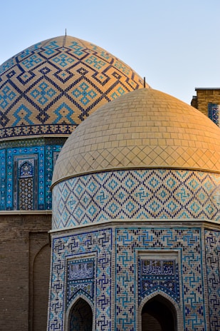 a close up of a building with a blue and gold dome