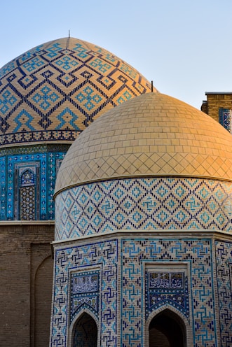 a close up of a building with a blue and gold dome