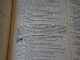 A close-up view of a printed text on a page, featuring paragraphs and sections with numbering. The text is laid out in columns, utilizing various font sizes and styles to denote different sections.