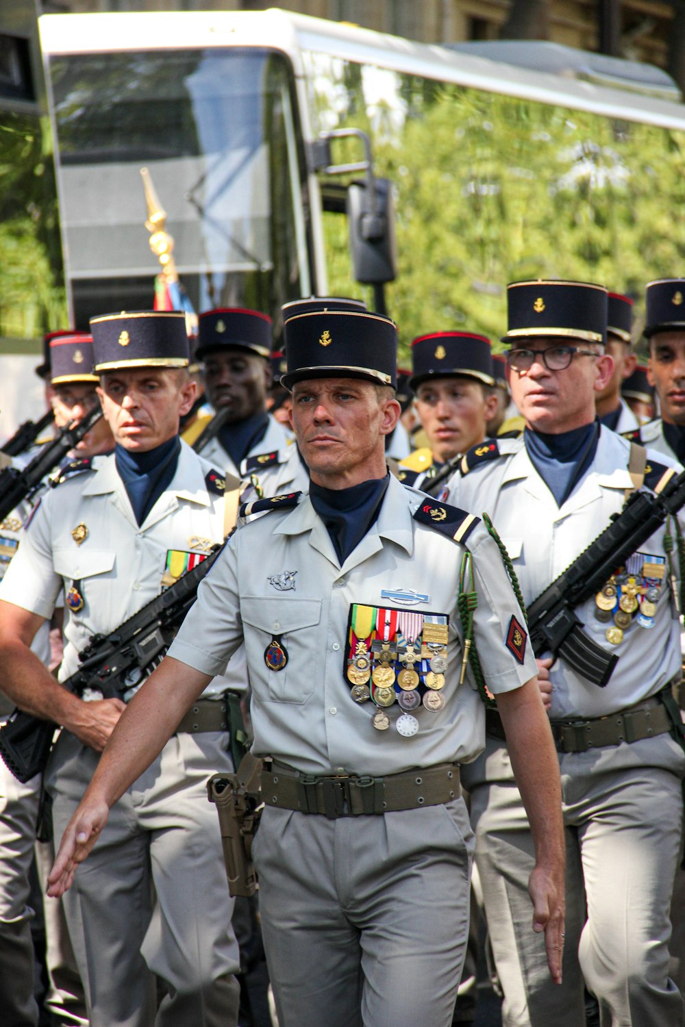 a group of uniformed men walking down a street