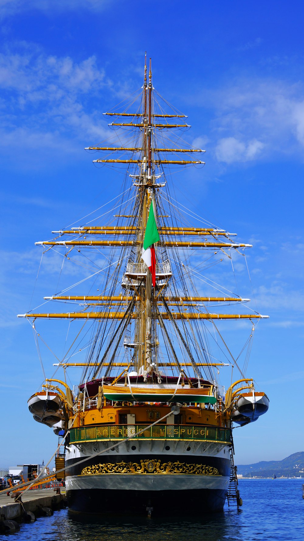 a large boat with a flag on it in the water