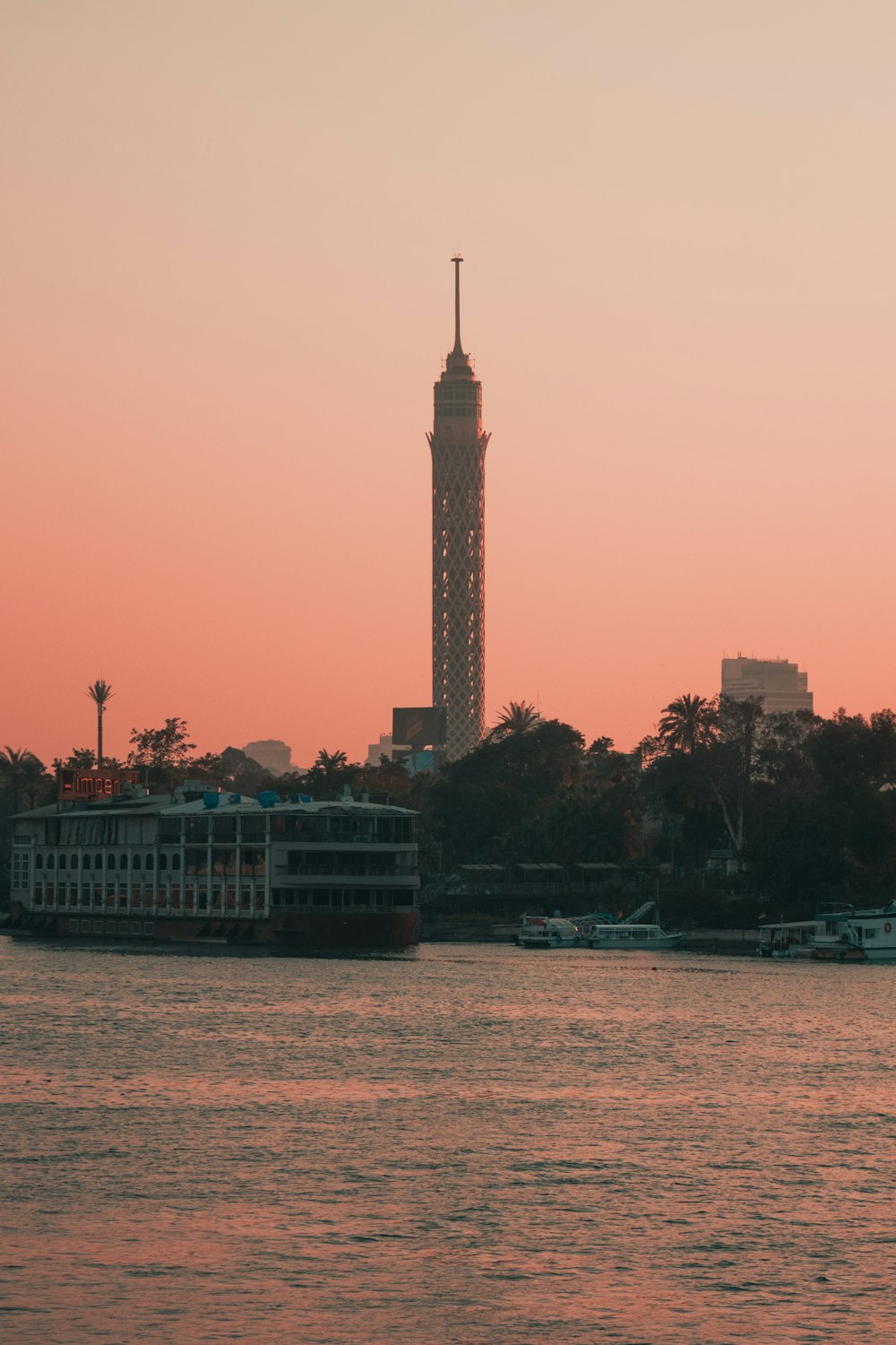 a large body of water with a tower in the background