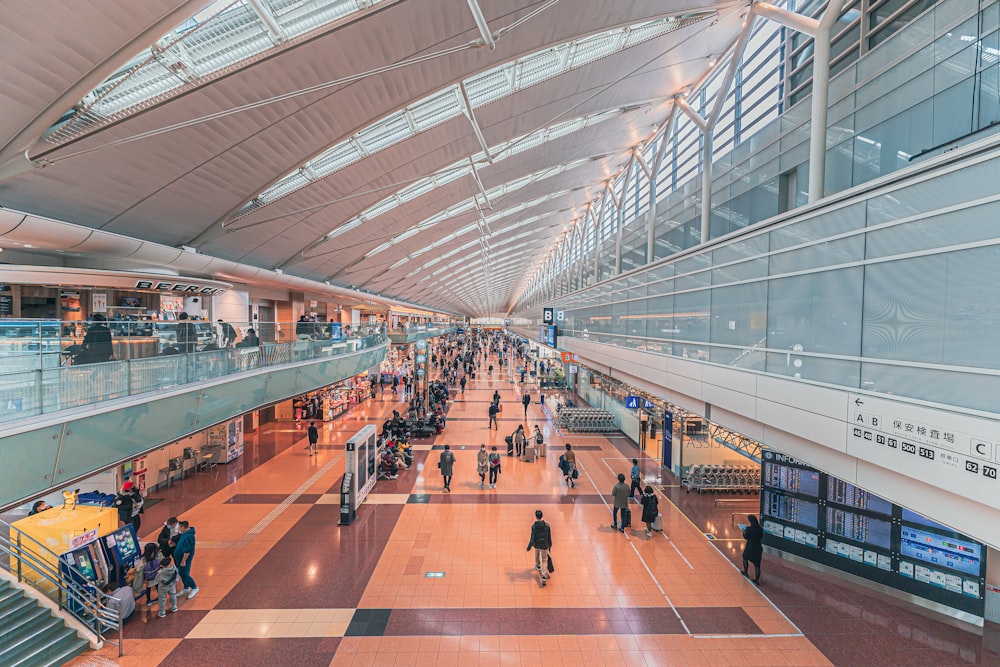 a group of people walking through an airport