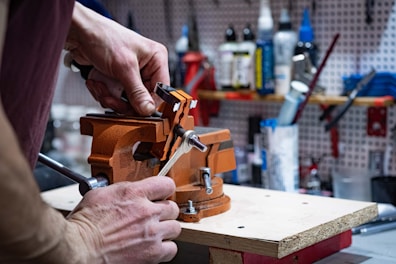 a man is working on a piece of wood