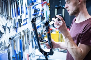 Technician inspecting suspension parts on a workbench with various tools