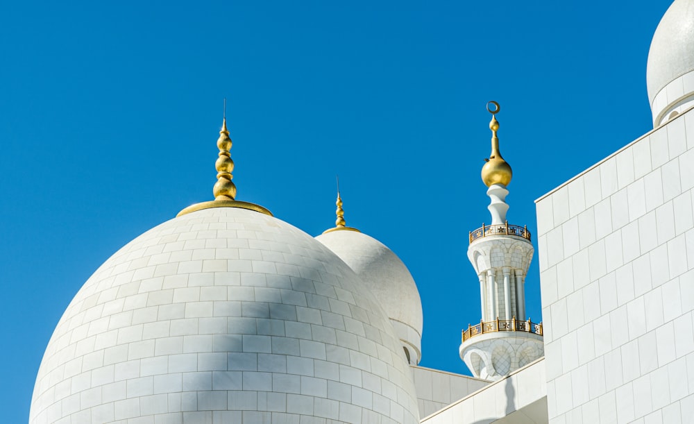 a large white building with two gold domes