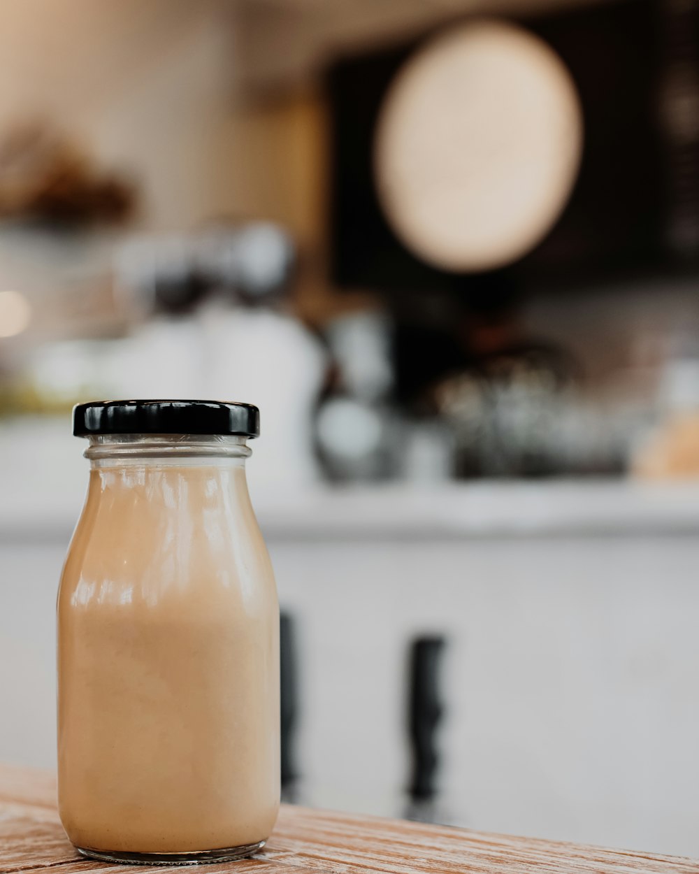 a bottle of milk sitting on top of a wooden table