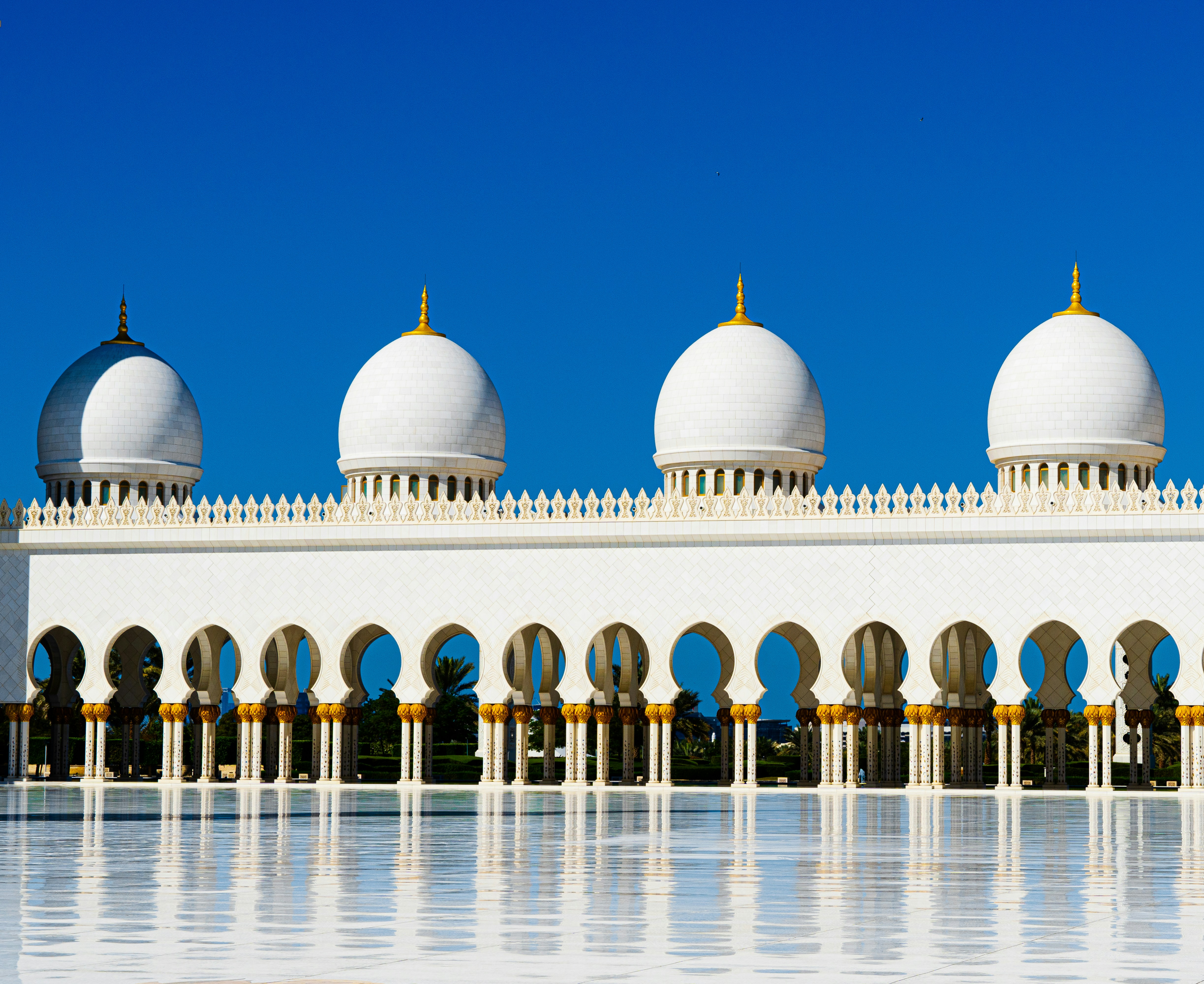 a large white building with arches and domes