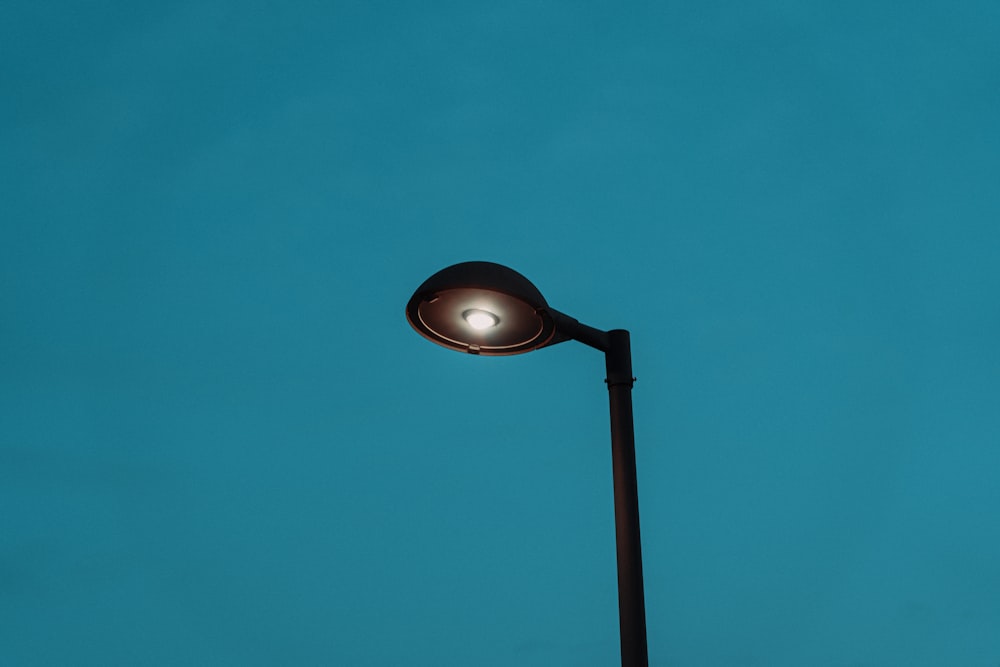 a street light with a blue sky in the background