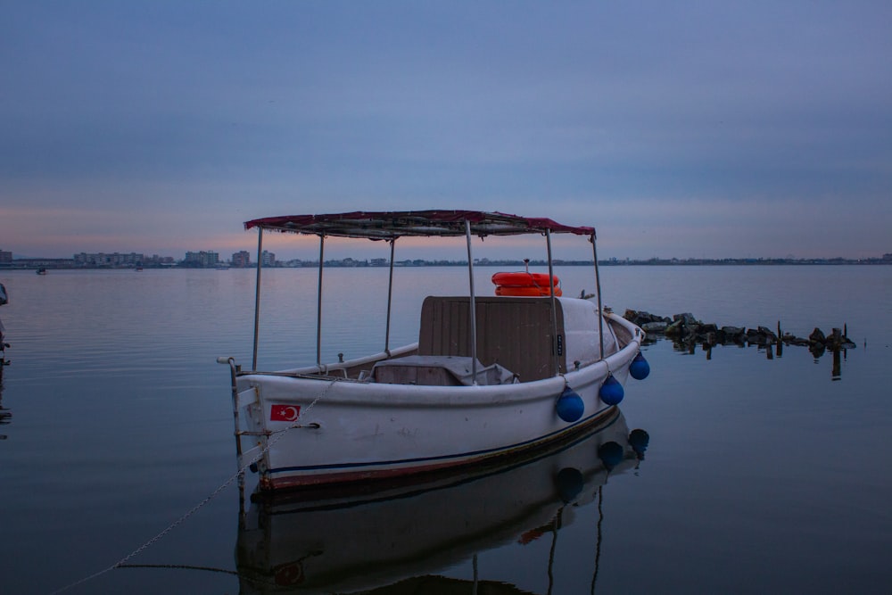 a small boat sitting on top of a body of water