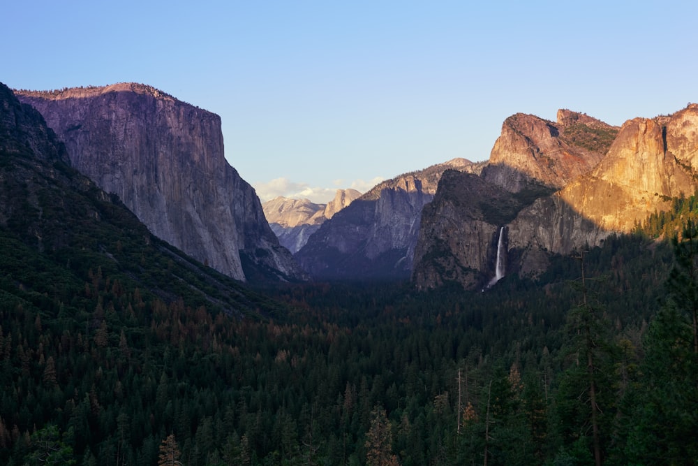 a view of a valley with a waterfall in the middle of it