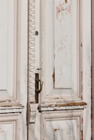 An old wooden door being carefully sanded and repaired by hand.