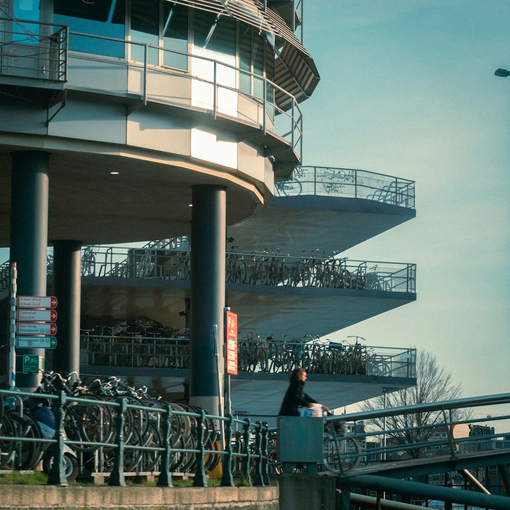 a man walking down a sidewalk next to a tall building