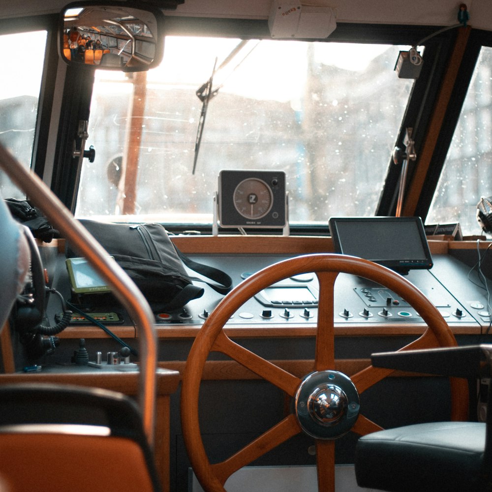 the inside of a bus with a steering wheel