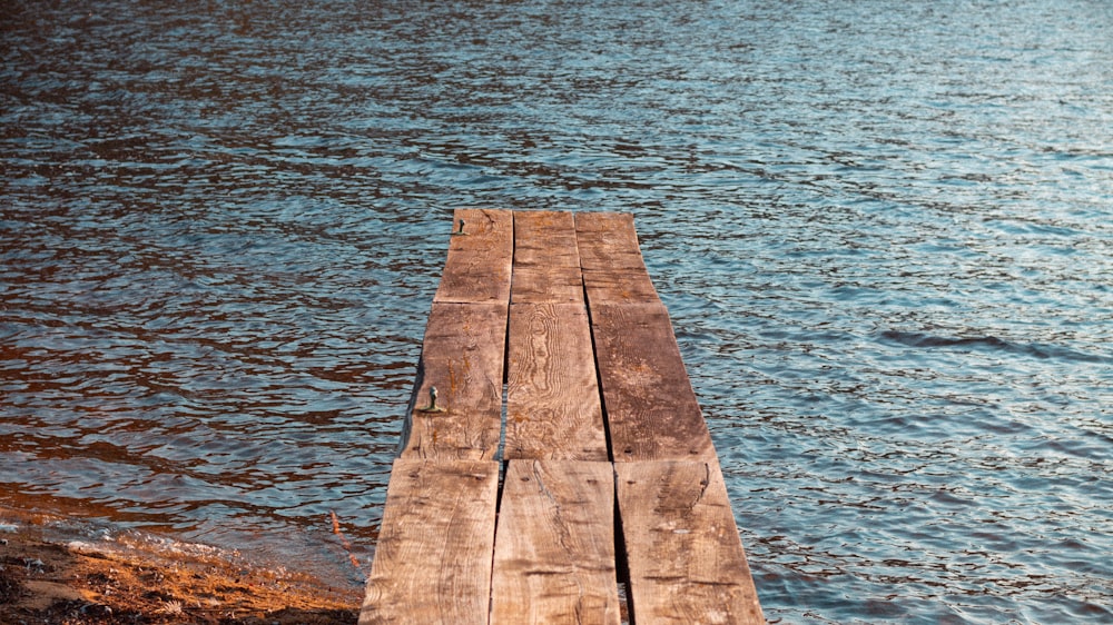 a wooden dock sitting in the middle of a body of water