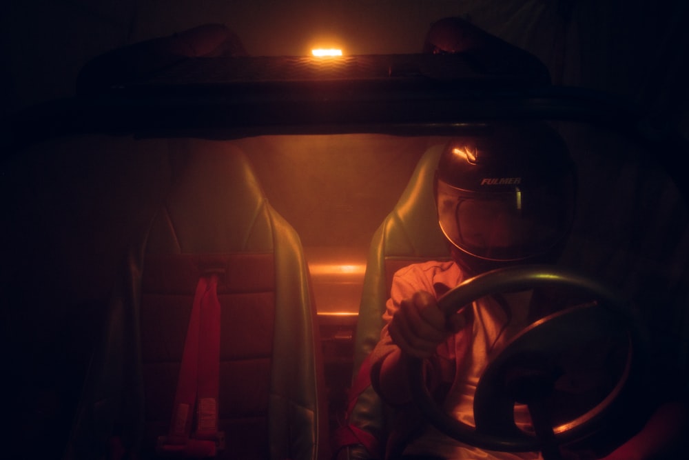 a man in a space suit sitting in a vehicle