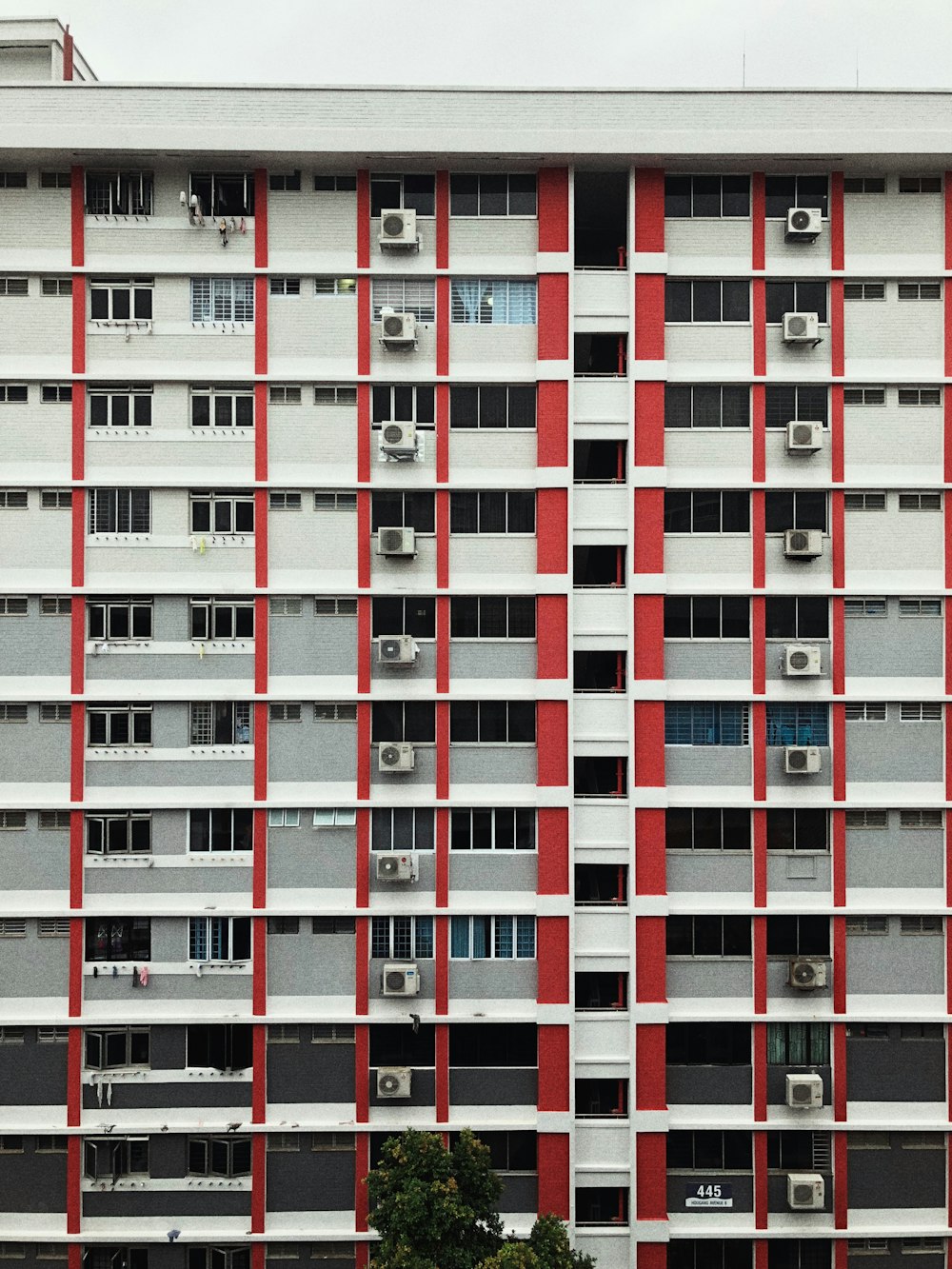 a tall red and white building with lots of windows