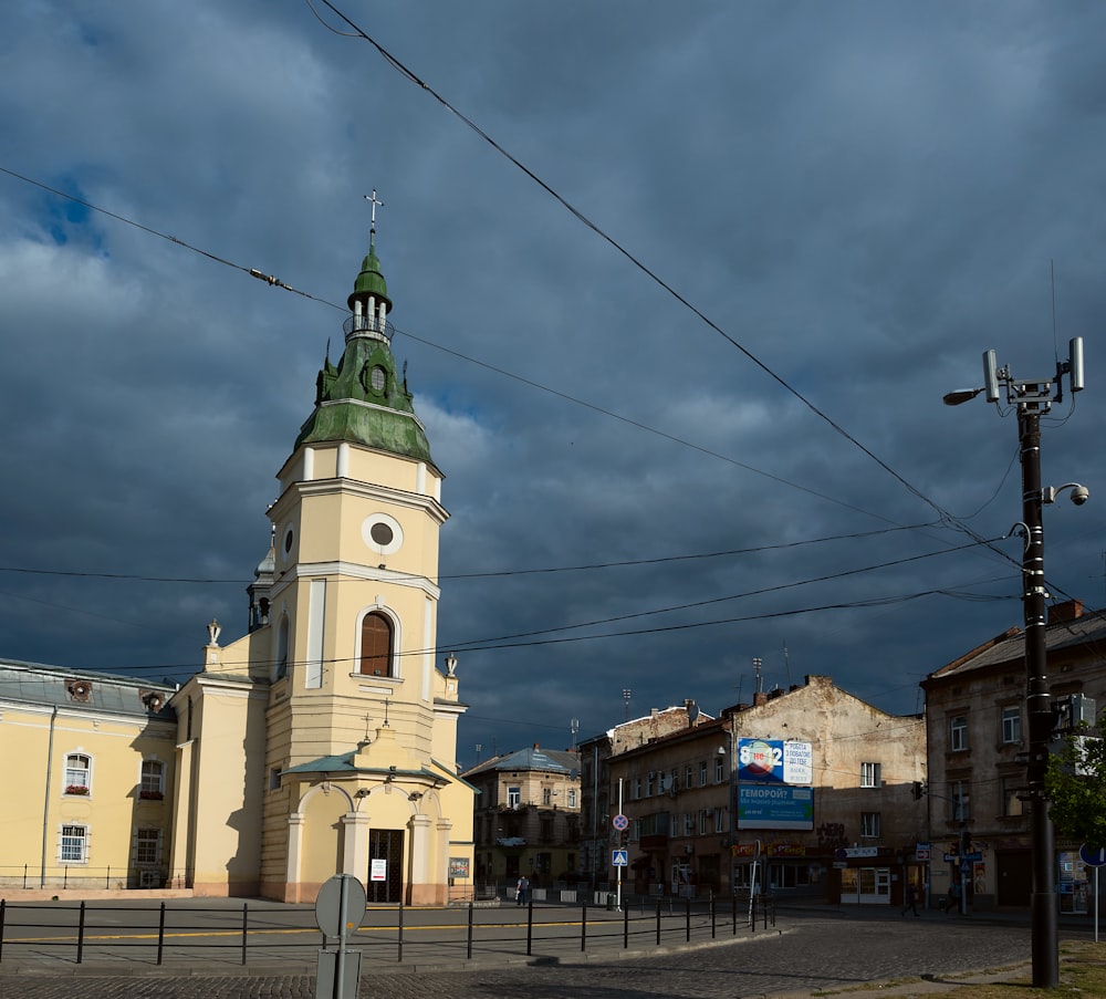 a church with a clock tower on a cloudy day