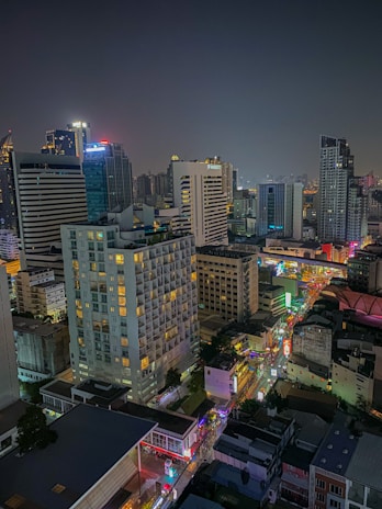 Evening cityscape with illuminated storefronts highlighting local businesses thriving after hours.