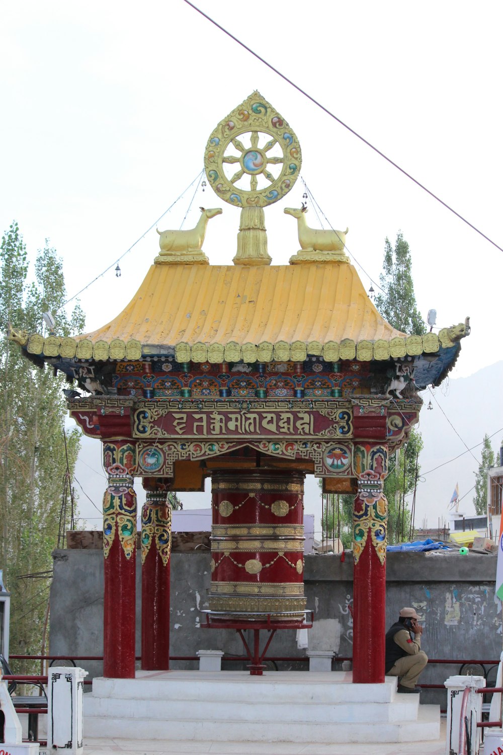 a red and yellow structure with a clock on top of it