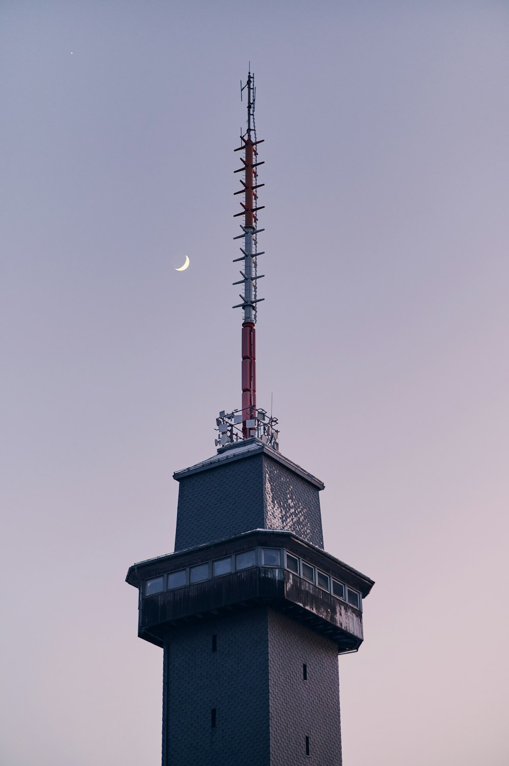 a very tall tower with a clock on it's side