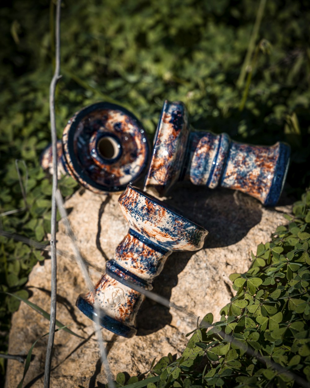 a rusted out fire hydrant sitting on top of a rock