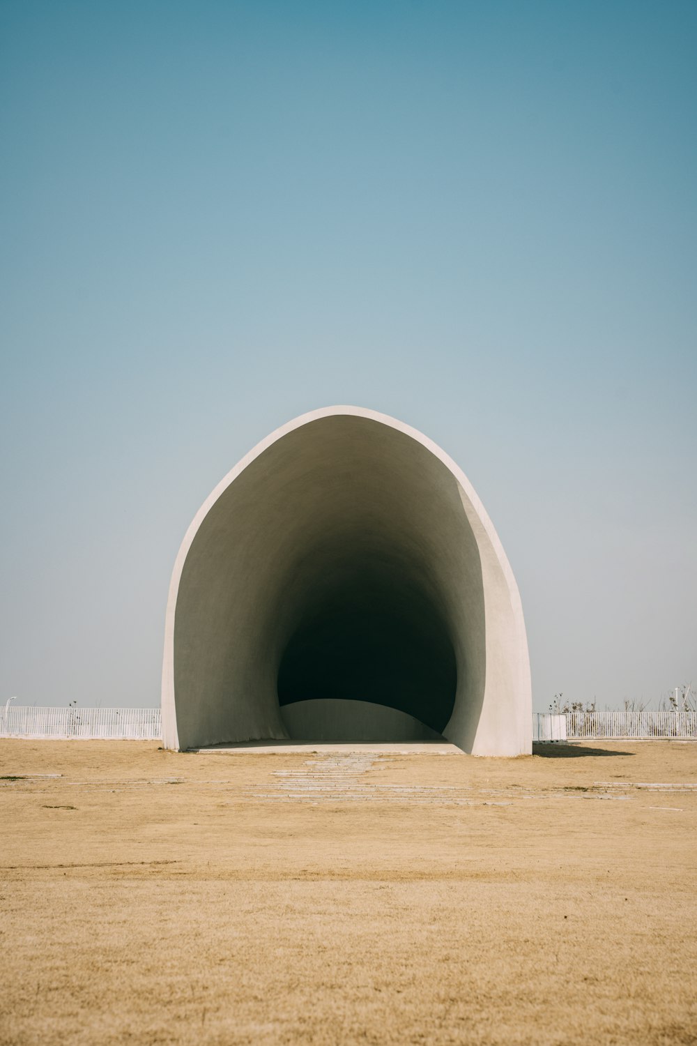 a large concrete structure sitting in the middle of a field