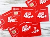 a group of red sim cards sitting on top of a wooden table