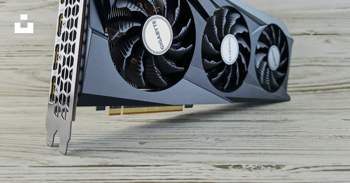 Gpu With Rounded End A close up of a graphics card on a wooden surface photo – Free Hardware ...