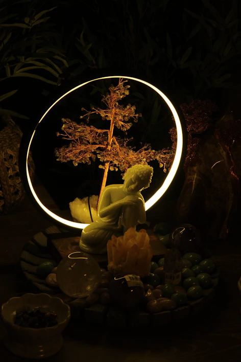 A serene altar with candles, crystals, and a small statue of a meditating figure.