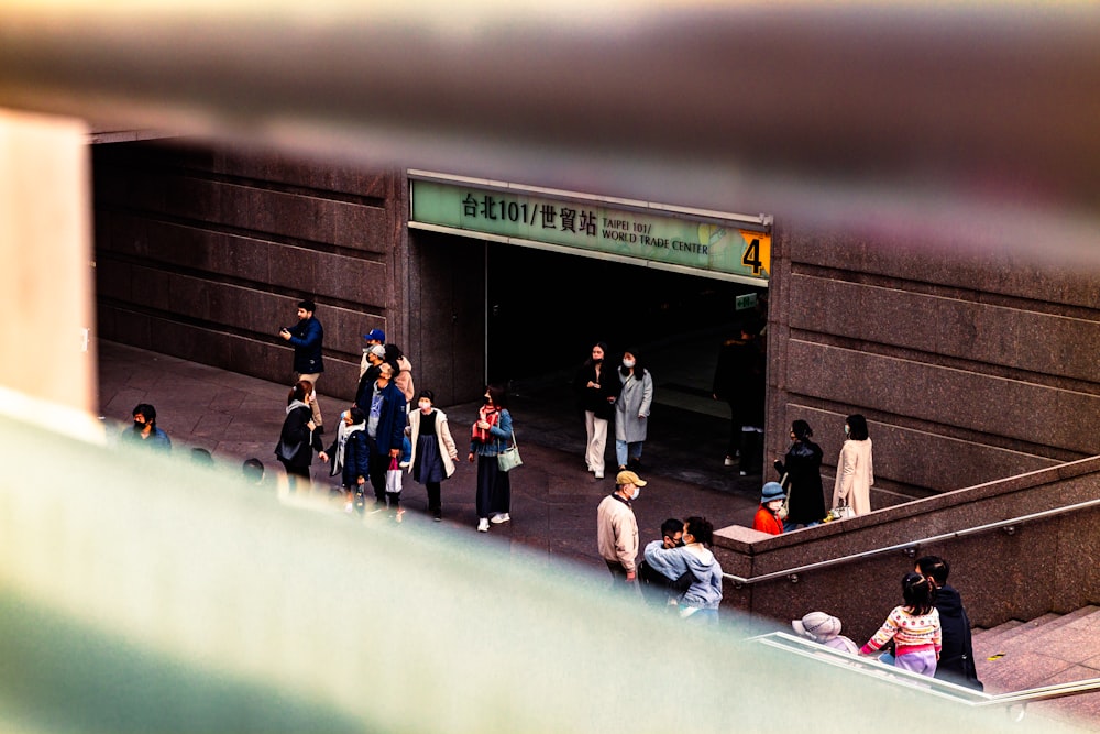 a group of people standing outside of a building