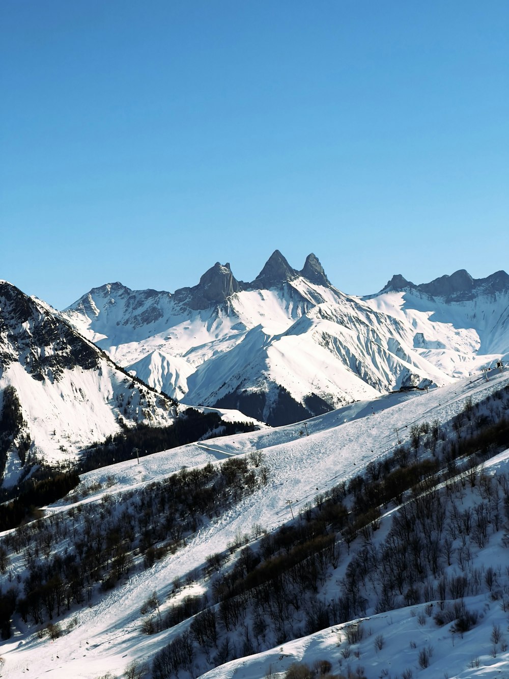 a view of a mountain range covered in snow