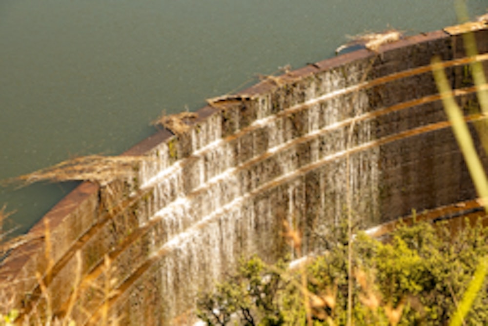 a large dam with water coming out of it